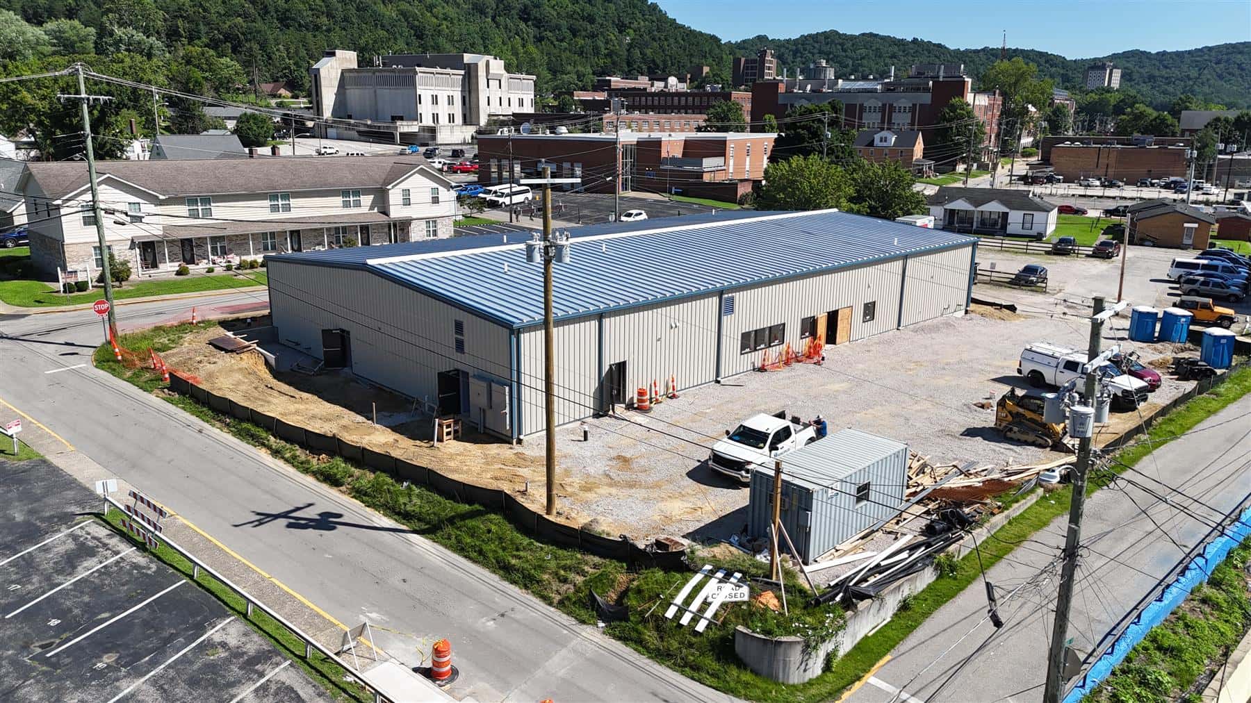 Overhead aerial of the enclosed senior-care building, July 2026